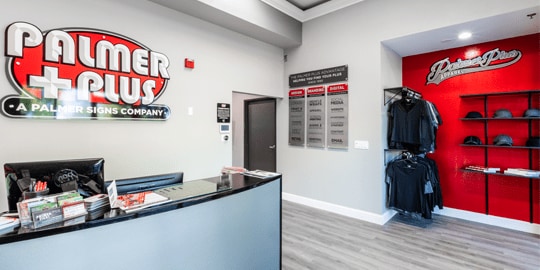 Sleek office with gray and red tones and modern signage.
