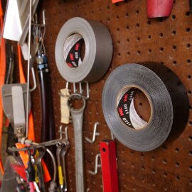 Pegboard with tools, including two rolls of 3M industrial duct tape