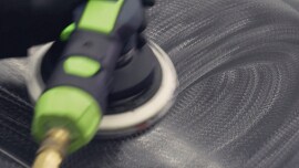 Sander being used on large surface of a car