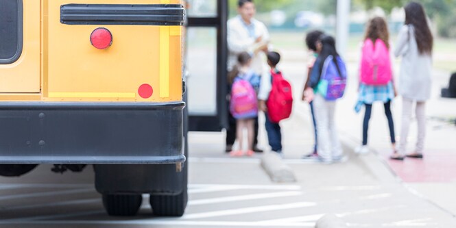 an image of two children standing at the yellow carpet school zone in Korea

