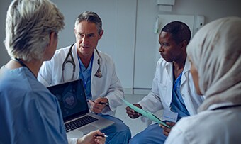 Clinician using a tablet to share resources with a patient
