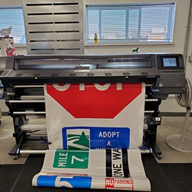 various traffic signs being printed on to a sheet from a digital printer