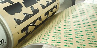 Image of a die-cut roll of tape being wound on a roll
