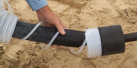 worker unwinding 3M cold shrink splice
