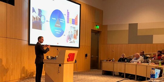 Speaker presenting at a 3M robotics conference