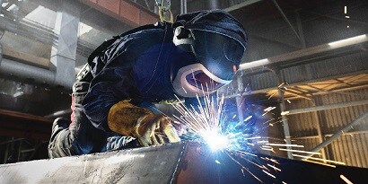 A person welding a piece of metal
