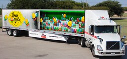 long fleet truck with a colorful graphic wrap.