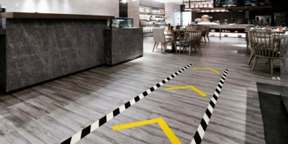 Image of a floor with traffic lane marked with black-and-white stripe tape
