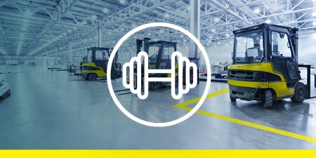 Image of forklifts on a taped-off factory floor
