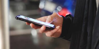 A hand holding a mobile phone