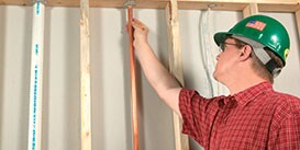 Inspector reviewing the firestop around a copper pipe as it goes up through a floor penetration​

