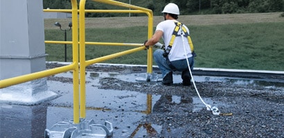 Worker setting up temporary guardrail system
