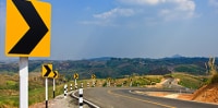 A highway road with yellow signs
