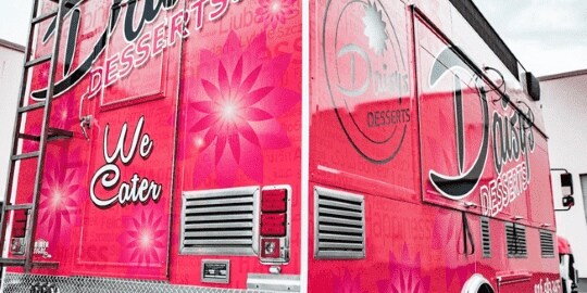 Daisy’s Desserts food truck with cursive lettering and pink background with flowers.
