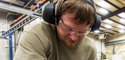 A person wearing headphones and glasses
