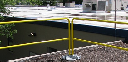 Temporary guardrail system set up on corner of roof
