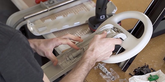 A person working on a steering wheel