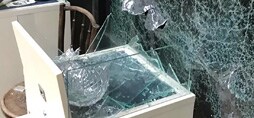 Image displays the results of a 3M Safety and Security Film after a window is broken.