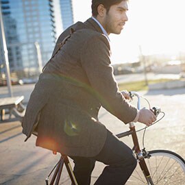 a man in a suit, cycling his way to work