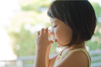 Girl consuming quality water at home
