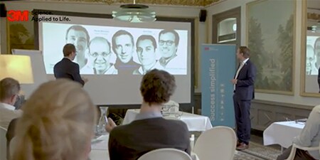 Group of people looking at a presentation around Success Simplified