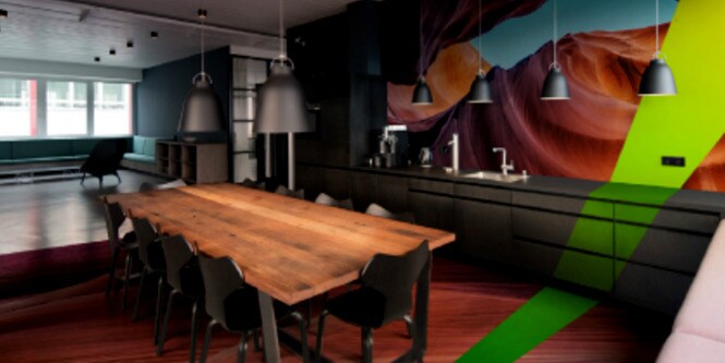 A medium shot of a modern indoor setting with colorful, new-age wall images. 
