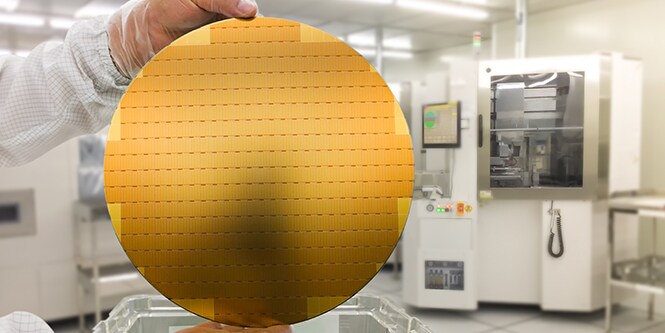 image of someone holding a semiconductor silicon wafer

