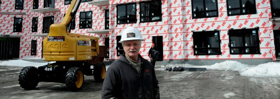 Image of Birkshire Developments founder Mike Young in front of a building where a 3M air barrier membrane has been applied​