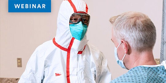 Clinician wearing PPE near patient
