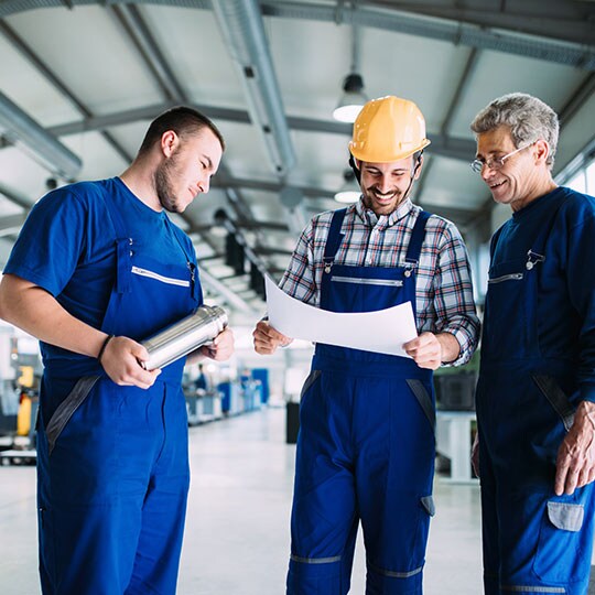 Three men working in a facility