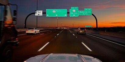 reflective traffic signage on highway at night.
