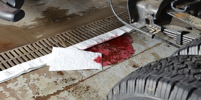 oil and petroleum spill on a car mechanic cement floor
