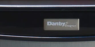 A branded nameplate on an appliance front
