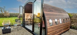 A glamping pod exterior features a faux wood 3M DI-NOC Architectural film.