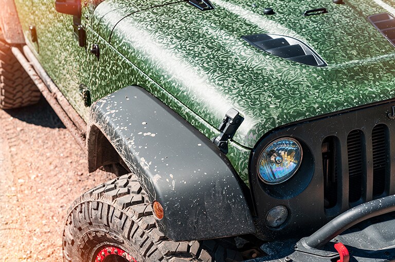 green jeep with a black bumper
