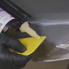 worker doing small damage metal car dent repair