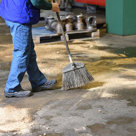 Person sweeping inside of a facility