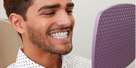 Man smiling to show natural colour of 3M™ Clarity Advanced dental ceramic braces.
