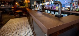 A pub bar counter that has been resorted with a 3M film.