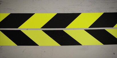 Video still of two yellow-and-black tapes next to each other
