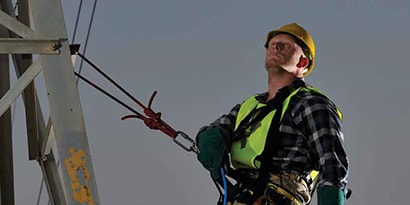 Scotch application image of man on electrical tower.
