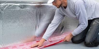 Person applying firestopping product to wall
