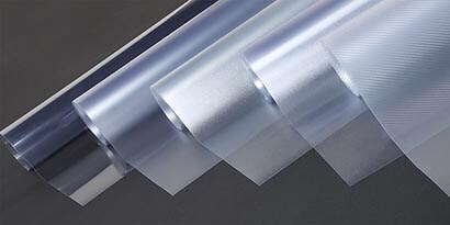 Rlls of 3M overlaminates and protection films side-by-side showing different textures and opacity.
