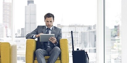 Man in suit using his tablet