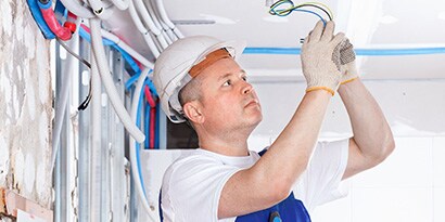 man working on light fixture
