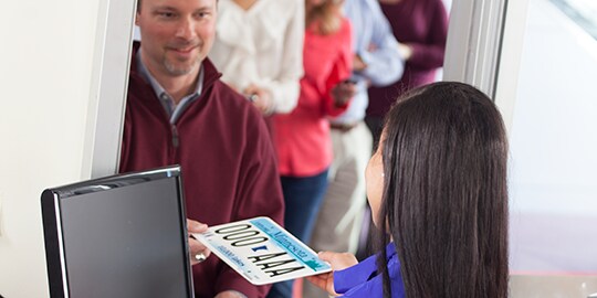 A person receiving his vehicle registratoin
