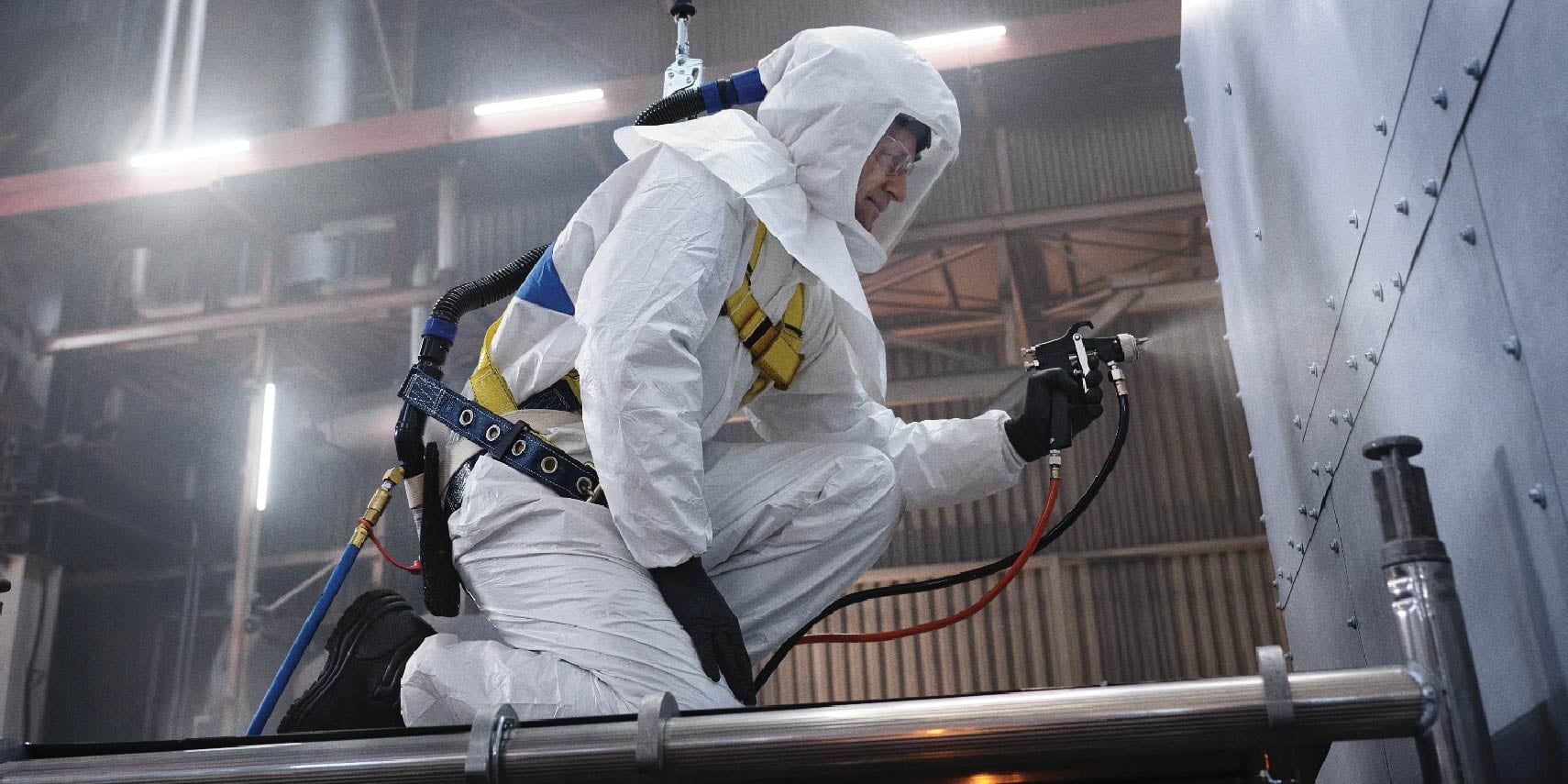A person in a white protective suit

