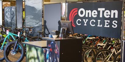 Bikes sitting in front of a banner behind a 3M retail signage film wrapped front desk.
