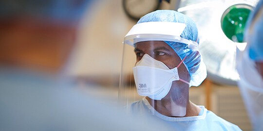 surgeon wearing PPE for infection prevention in surgery
