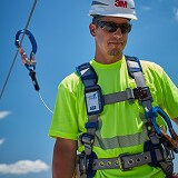 Worker in harness attached to fall protection lifeline